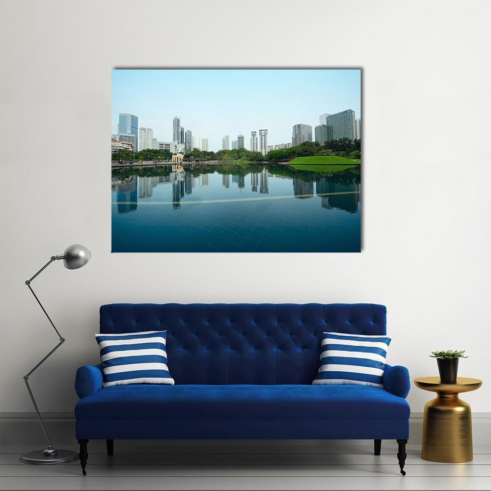 City Skyline Reflected in Water Canvas Wall Art in white, green and blue, single panel hung on a wall
