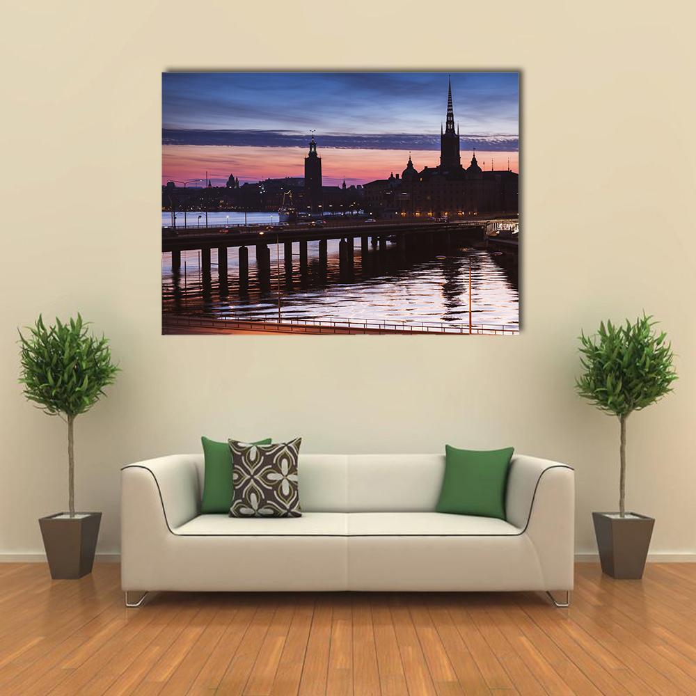 Stockholm Sunset Skyline with Church Spire Canvas Wall Art in orange, blue and purple, single panel hung on a wall