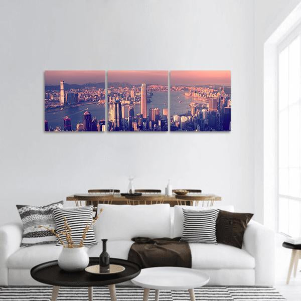 Purple Dusk City Skyline Over Harbor Panoramic Canvas Wall Art in blue, purple and pink, hung on a wall