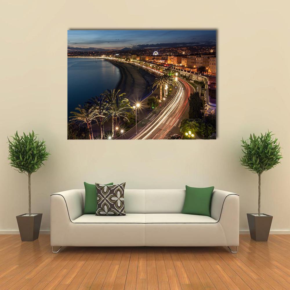 Coastal City Nightscape with Light Trails Canvas Wall Art in black, yellow and blue, single panel hung on a wall