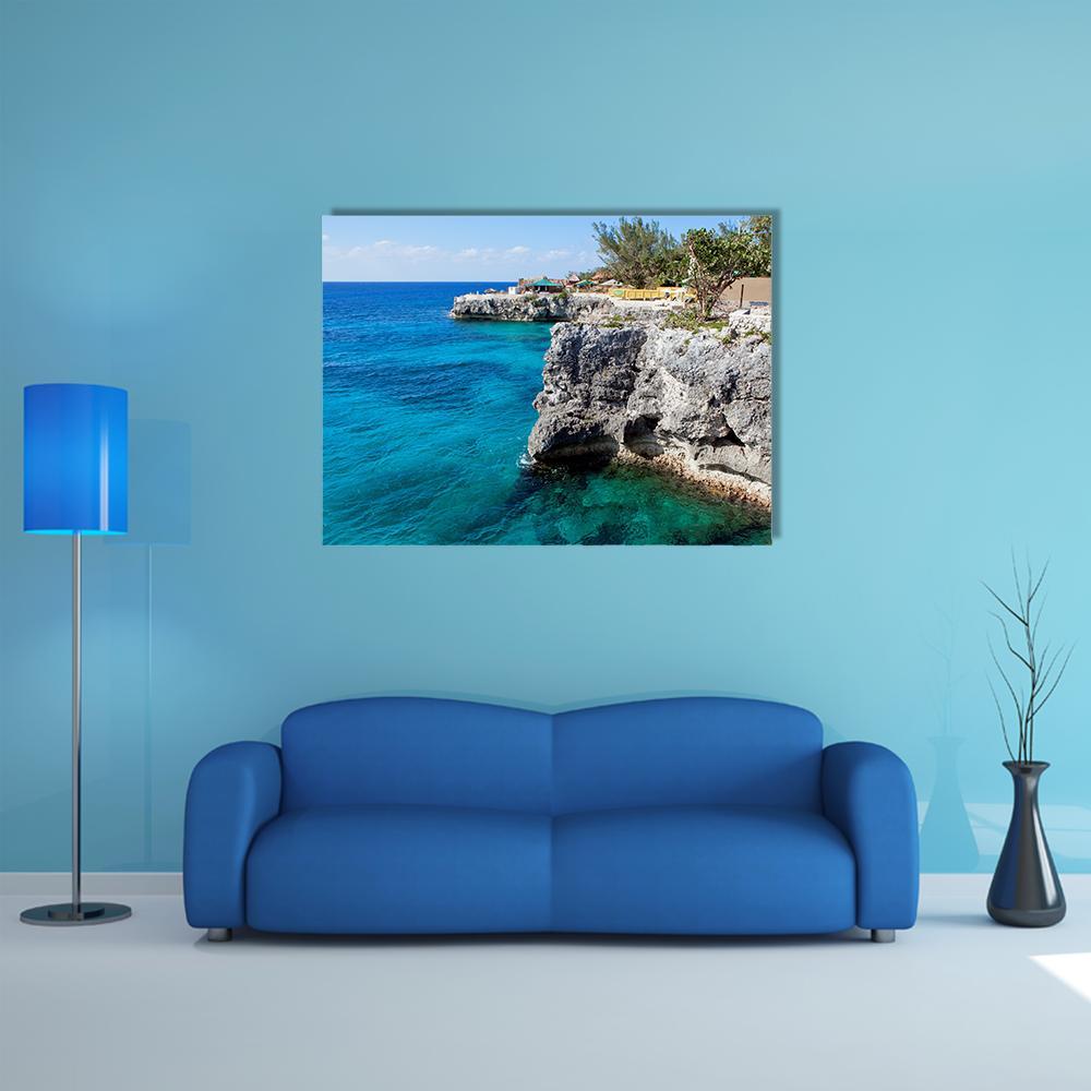 Turquoise Ocean Cliffs with Tropical Vegetation Canvas Wall Art in gray, green and blue, single panel hung on a wall
