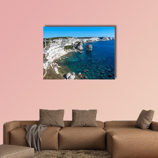 Cliffs of Bonifacio with Turquoise Water Canvas Wall Art in white and blue, single panel hung on a wall