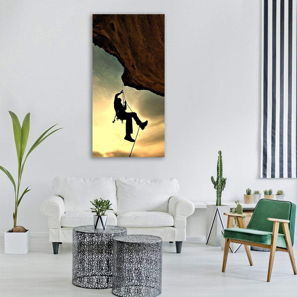 Mountain Climber at Sunset Vertical Canvas Wall Art in black, brown and yellow, single vertical panel hung on a wall