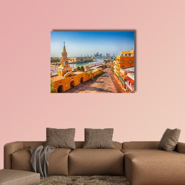 Clock Tower Gate, Colombia Canvas Wall Art in orange, yellow and blue, single panel hung on a wall