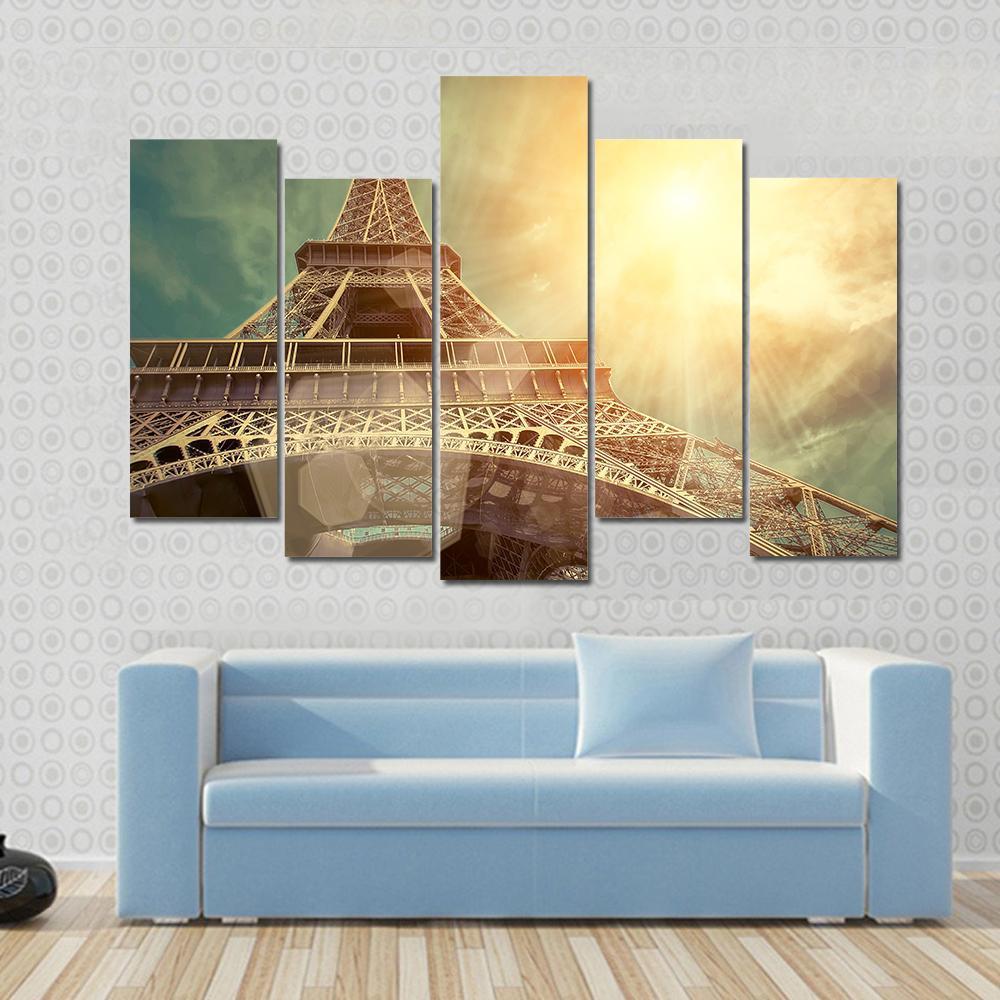 Close Up Eiffel Tower Canvas Wall Art in brown, gold and yellow, 5 panel Pop layout hung on a wall