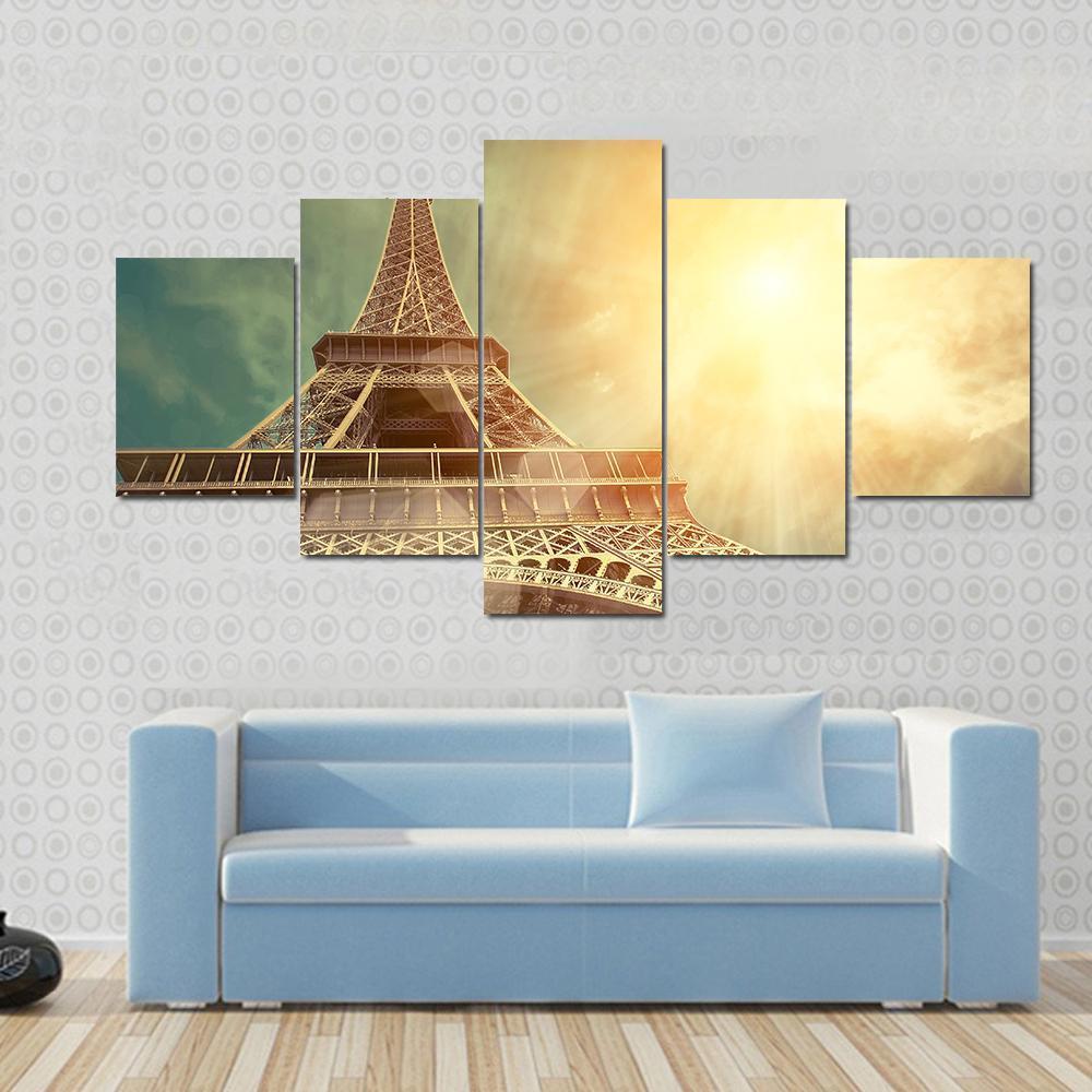 Close Up Eiffel Tower Canvas Wall Art in brown, gold and yellow, 3 panel horizontal set hung on a wall