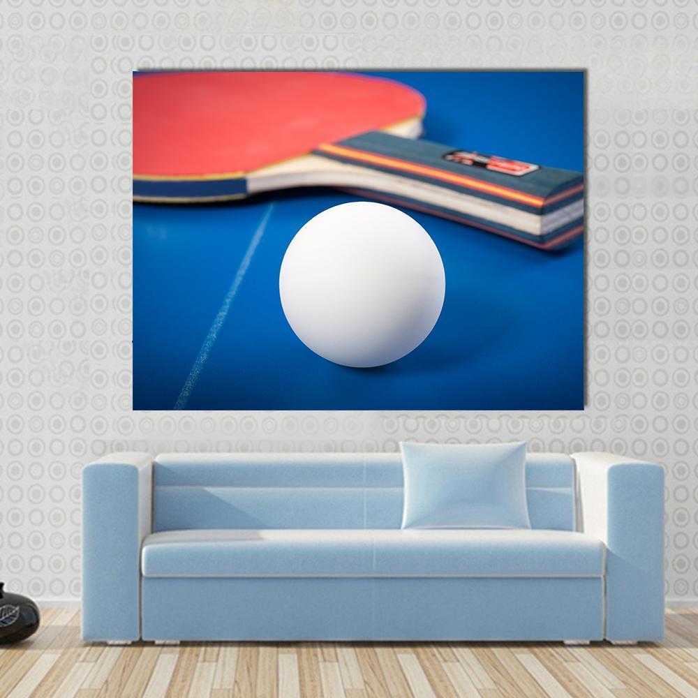 Table Tennis Ball and Racket Canvas Wall Art in white, red and blue, single panel hung on a wall