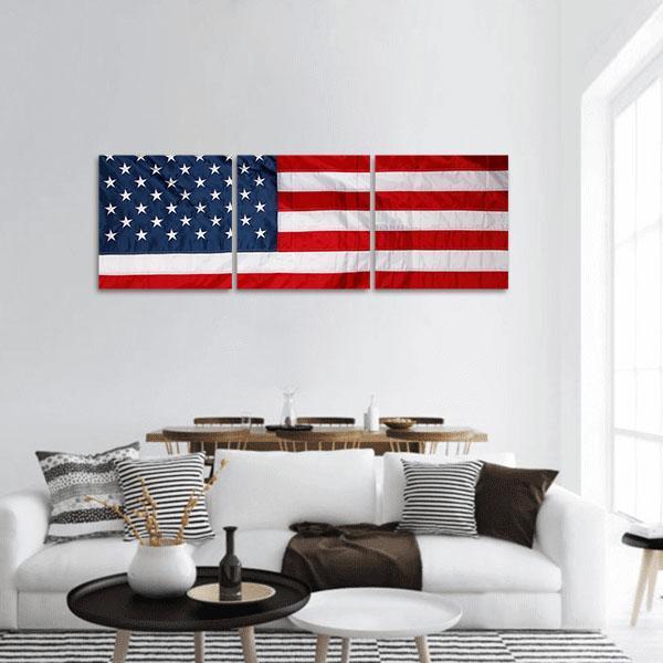 American Flag Close-up with Stars and Stripes Panoramic Canvas Wall Art in white, red and blue, hung on a wall