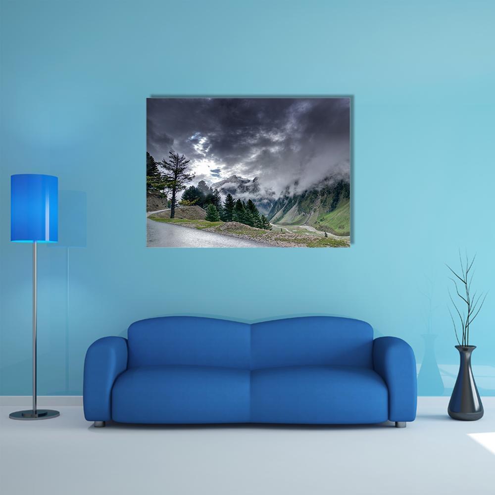 Winding Mountain Road Beneath Storm Clouds Canvas Wall Art in black, gray and green, single panel hung on a wall