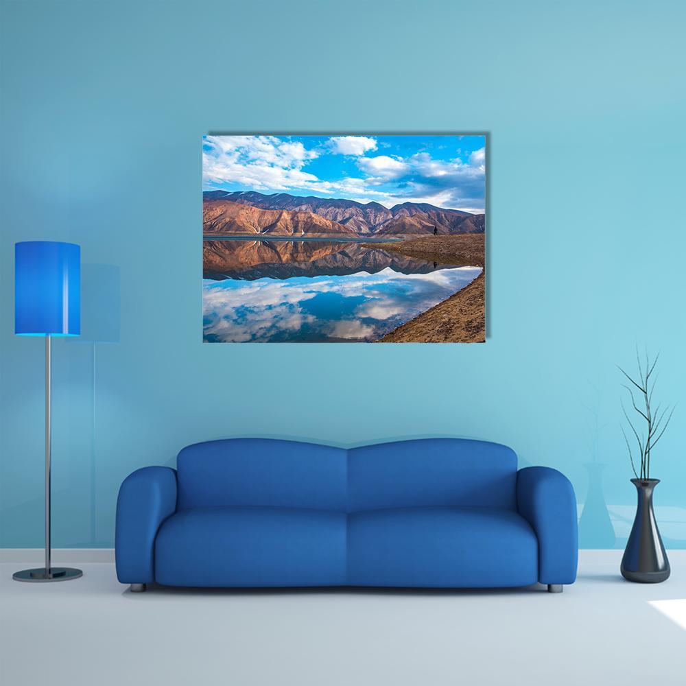 Clouds Reflected on River Canvas Wall Art in white, brown and blue, single panel hung on a wall