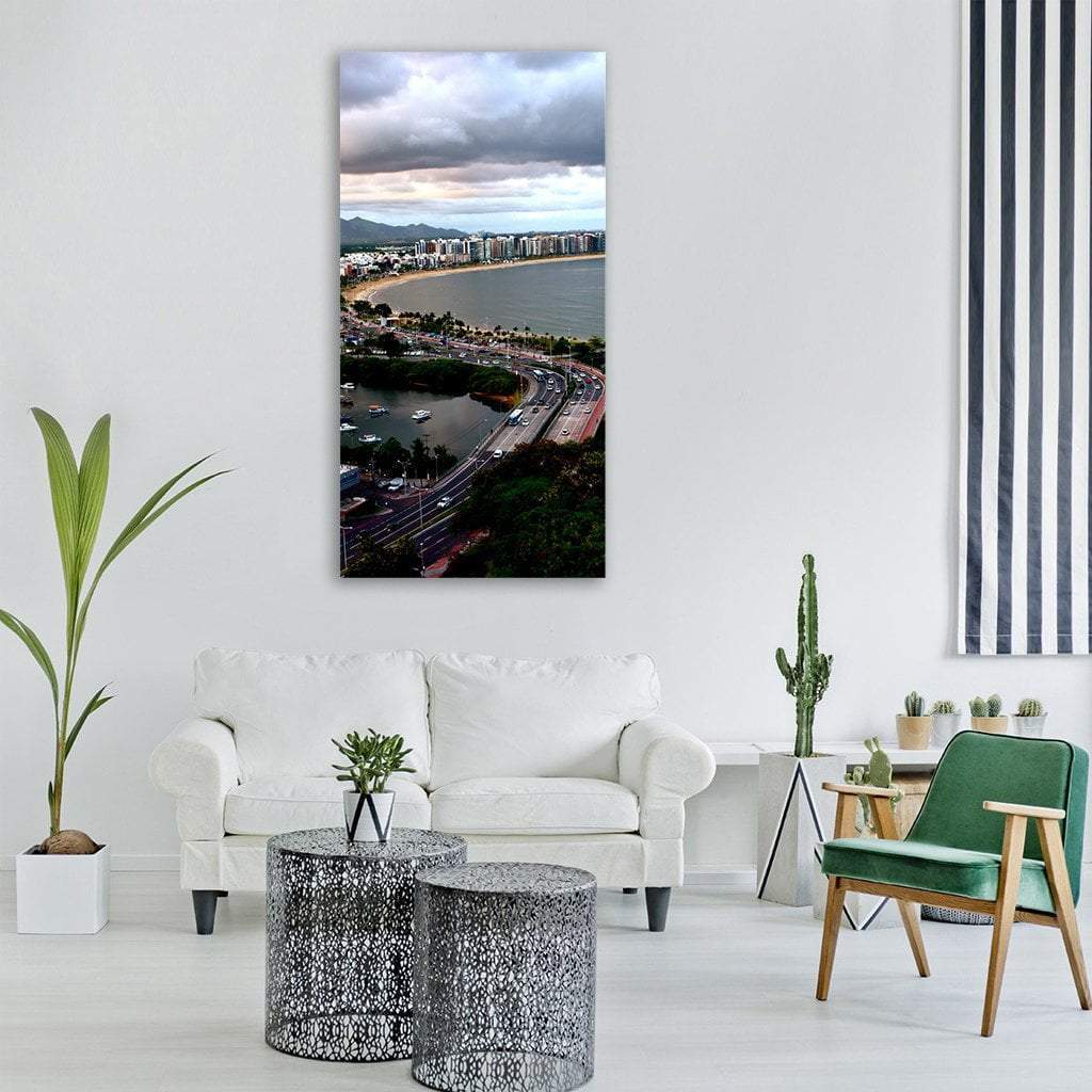 Cloudy Coastal Skyline with Bridge Vertical Canvas Wall Art in white, gray and blue, single vertical panel hung on a wall