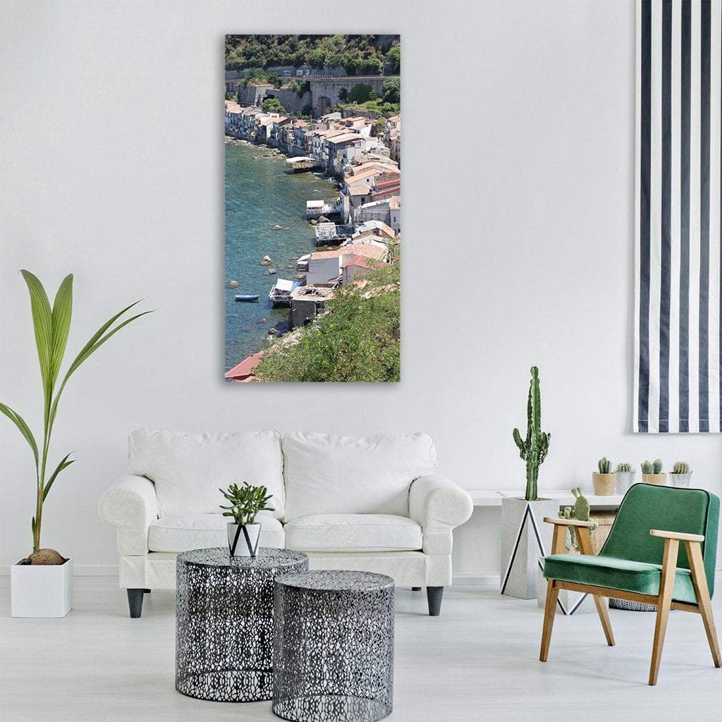 Mediterranean Village with Stone Arch Bridge Vertical Canvas Wall Art in beige, green and blue, single vertical panel hung on a wall