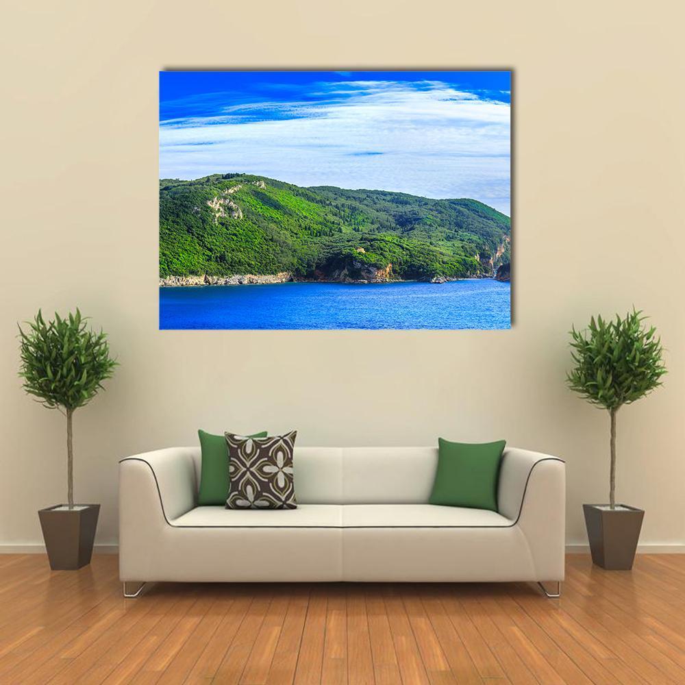Lush Greek Coastline Canvas Wall Art in white, green and blue, single panel hung on a wall