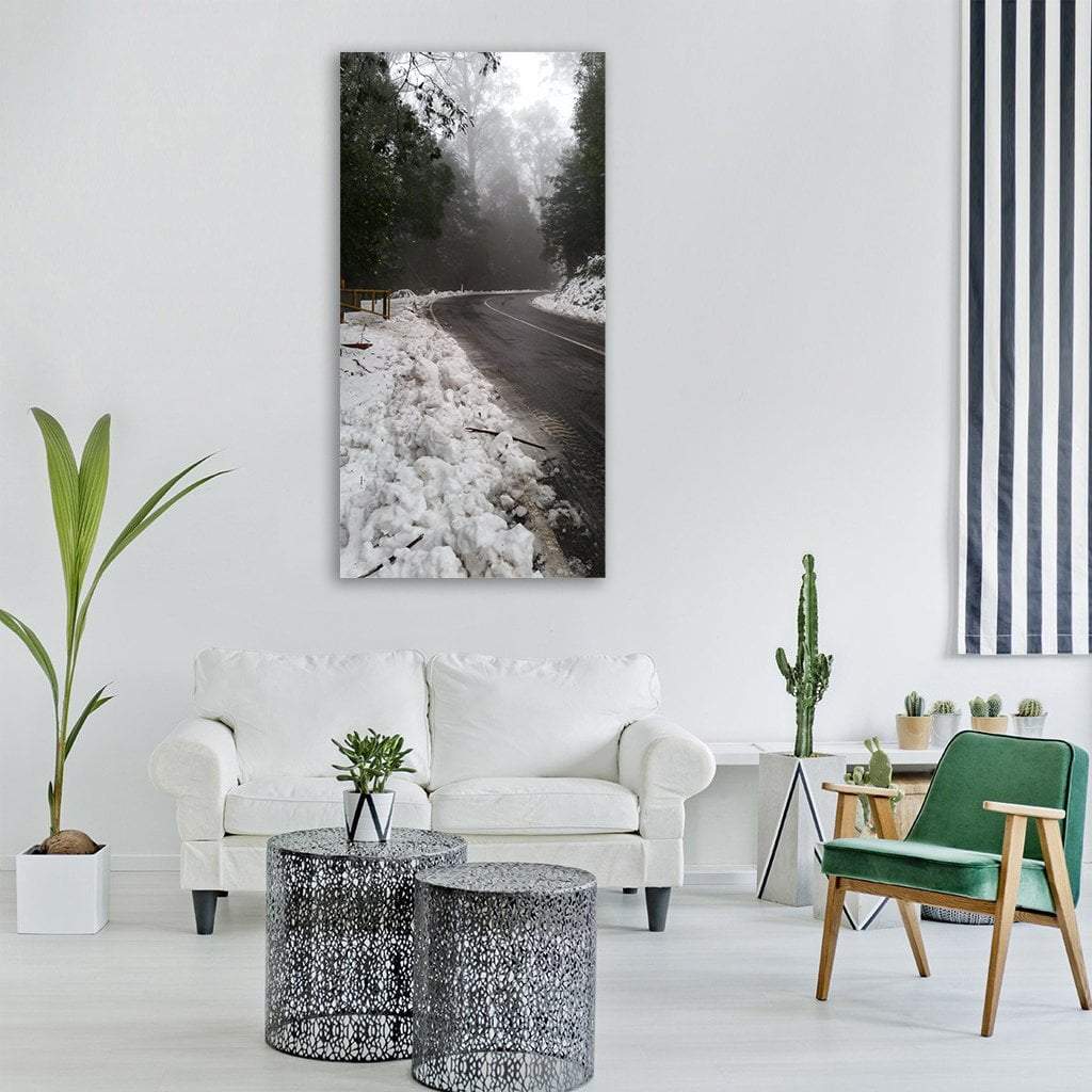 Foggy Winter Road Vertical Canvas Wall Art in black, white and gray, single vertical panel hung on a wall