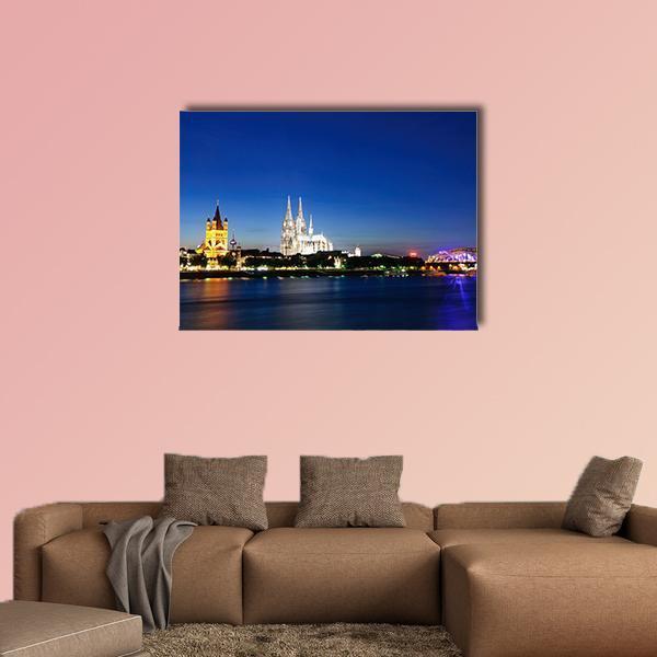 Cologne City at Night Canvas Wall Art in black and blue, single panel hung on a wall