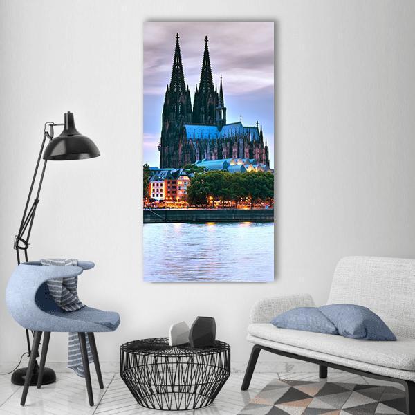 Cologne Cathedral Twin Spires at Dusk Vertical Canvas Wall Art in gray, blue and purple, single vertical panel hung on a wall