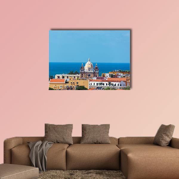 San Pedro Claver Church Canvas Wall Art in orange, yellow and blue, single panel hung on a wall