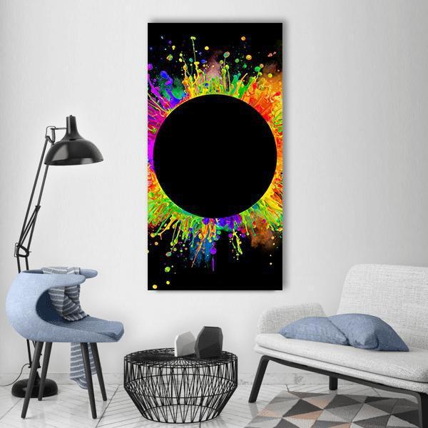 Black Circle with Color Splashes Vertical Canvas Wall Art in black and multicolor, single vertical panel hung on a wall