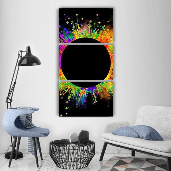 Black Circle with Color Splashes Vertical Canvas Wall Art in black and multicolor, hung on a wall