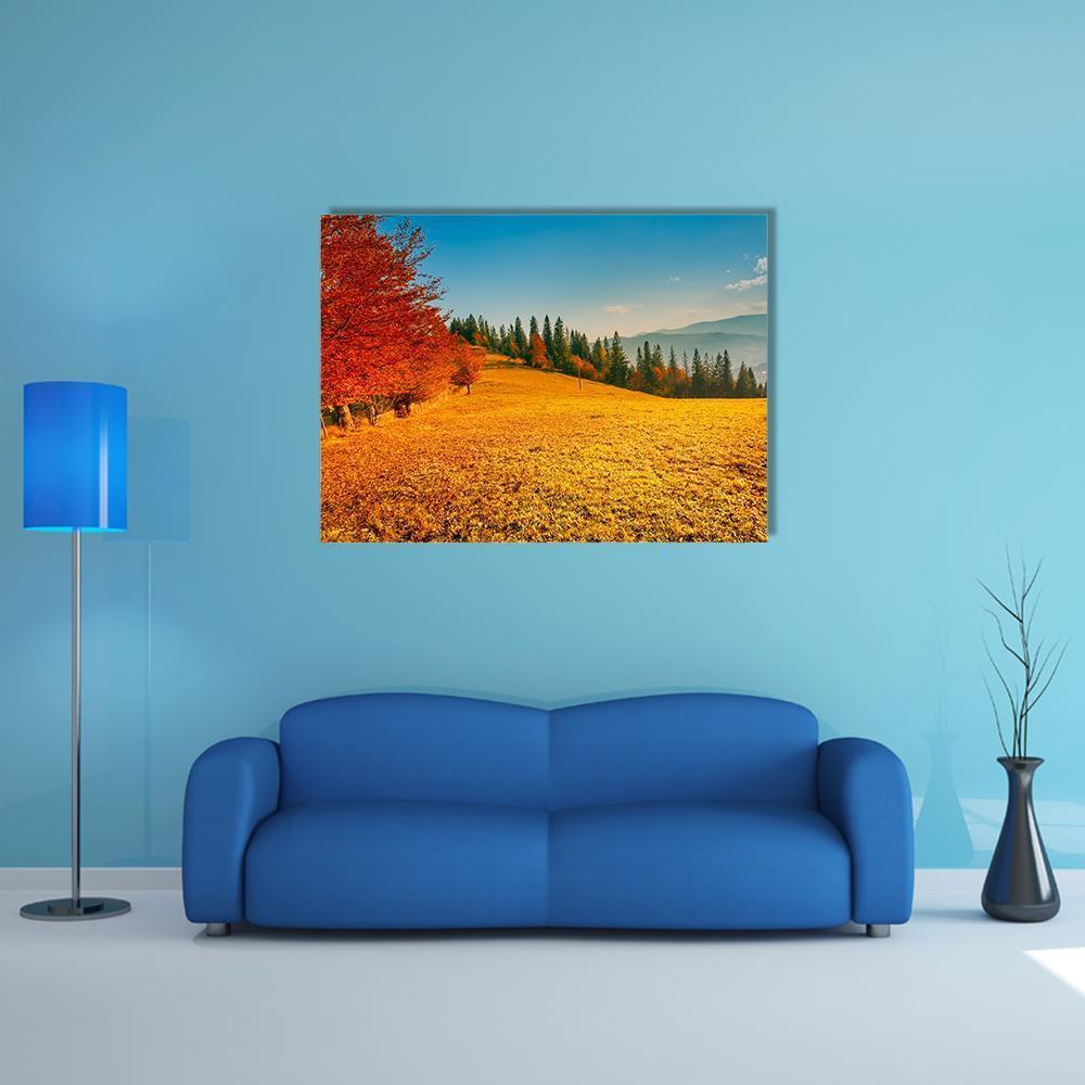 Colorful Autumn Landscape Canvas Wall Art in orange, yellow and blue, single panel hung on a wall