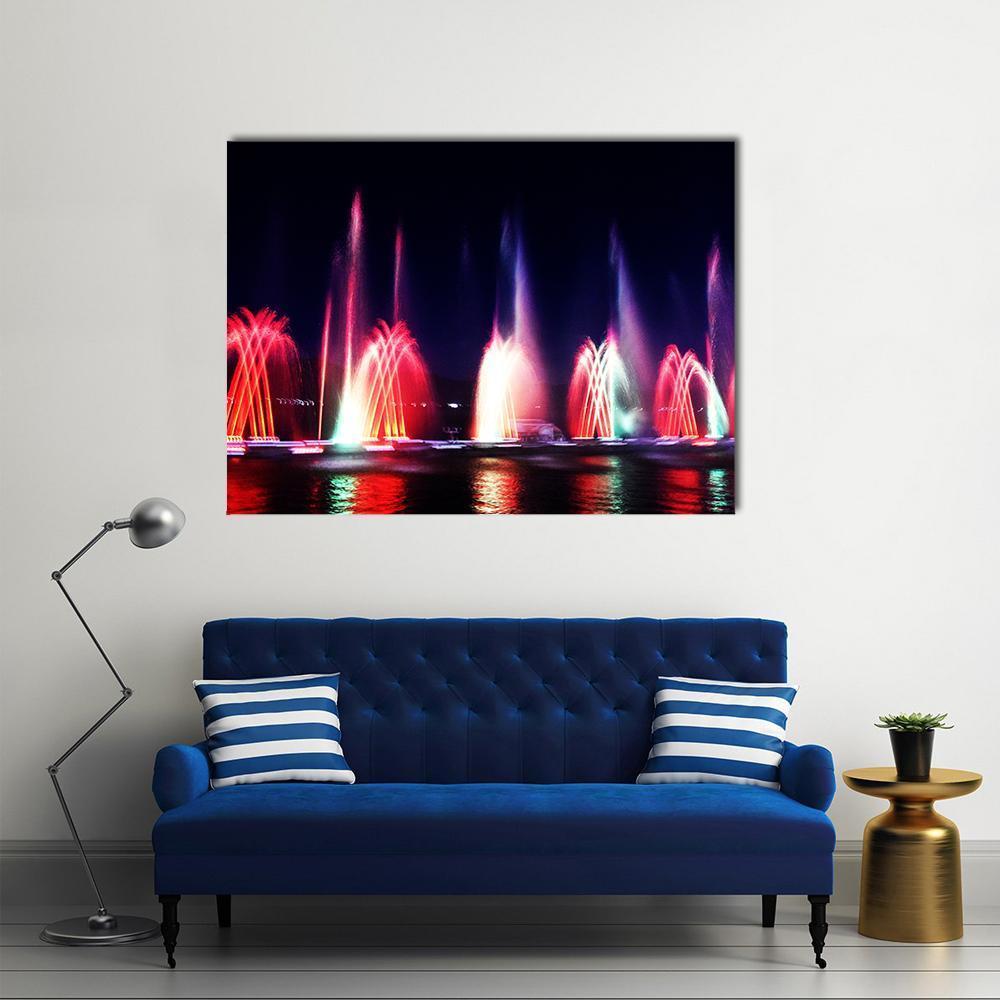 Vibrant Night Fountains with Colorful Lights Canvas Wall Art in black, red and multicolor, single panel hung on a wall