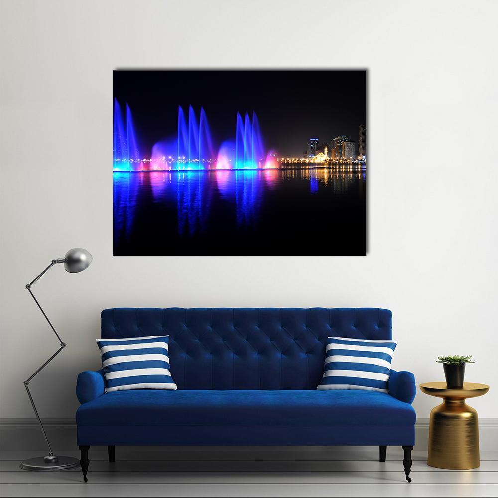 Vibrant Dancing Fountains at Night Canvas Wall Art in black, blue and purple, single panel hung on a wall