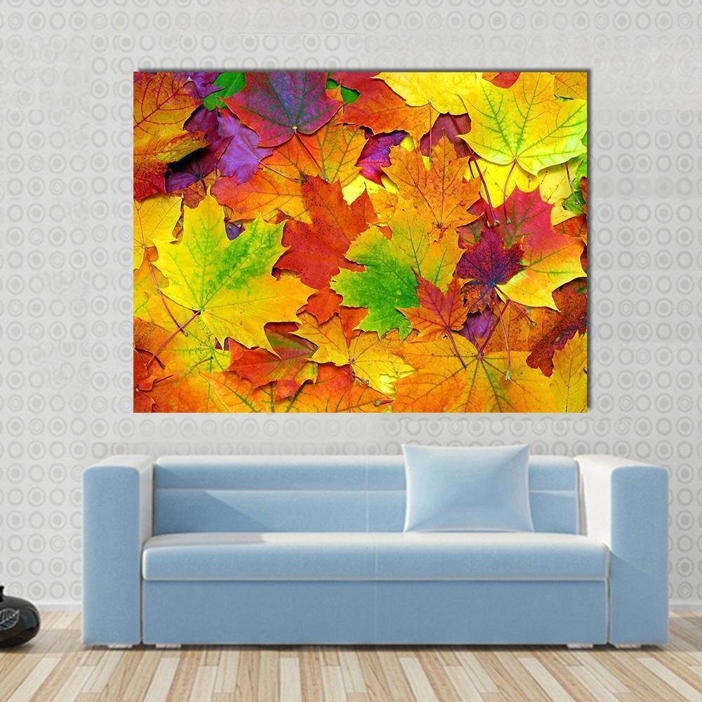 Colorful Leaves Canvas Wall Art in orange, yellow and multicolor, single panel hung on a wall