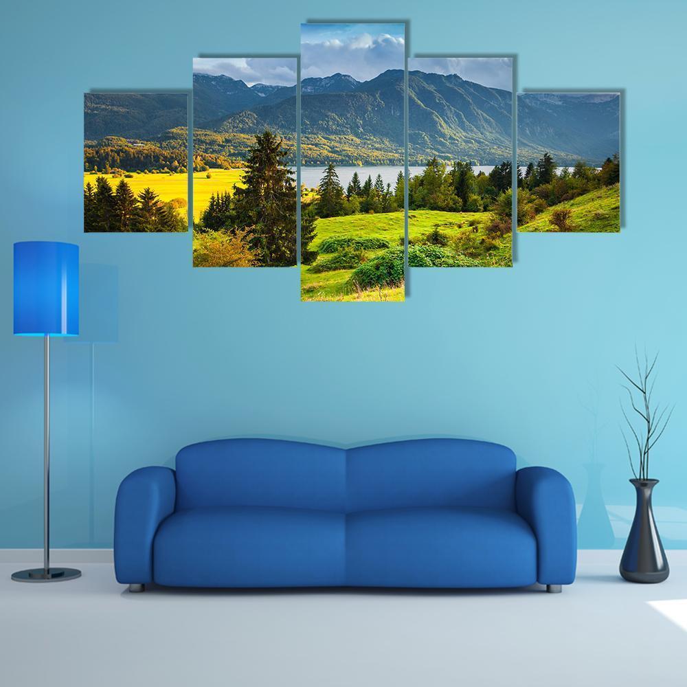 Morning on Bohinj Lake Canvas Wall Art in yellow, green and blue, 5 panel Star layout hung on a wall