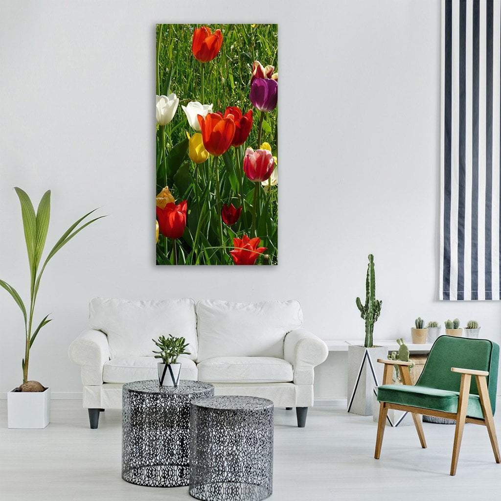 Vibrant Spring Tulips Vertical Canvas Wall Art in red, green and multicolor, hung on a wall