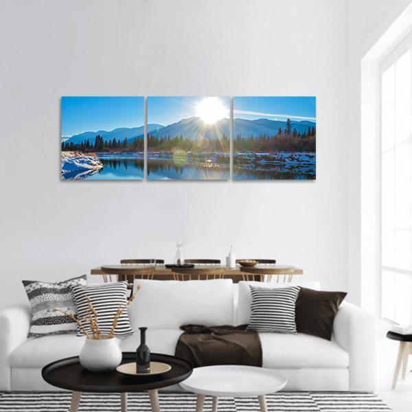 Columbia River Sunrise with Snow-dusted Shoreline Panoramic Canvas Wall Art in white and blue, hung on a wall