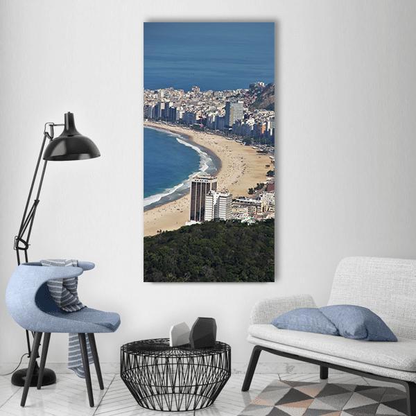 Curving Tropical Beach with City Skyline Vertical Canvas Wall Art in gray, beige and blue, single vertical panel hung on a wall
