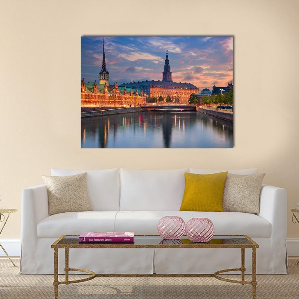 Copenhagen at Twilight Canvas Wall Art in orange, blue and pink, single panel hung on a wall