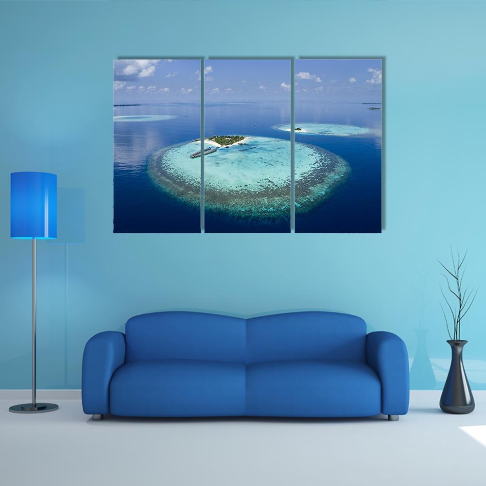 Maldives Coral Atolls Aerial View Canvas Wall Art in blue, 3 panel horizontal set hung on a wall