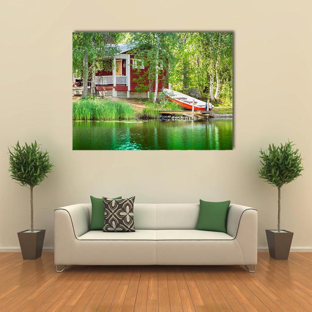 Red Cabin by the Lake with Docked Boat Canvas Wall Art in white, red and green, single panel hung on a wall
