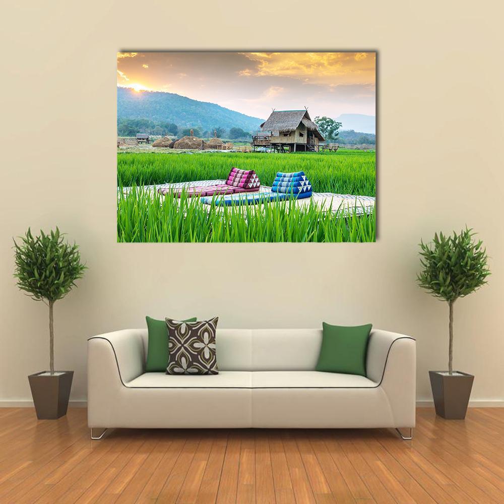 Couch in Rice Field at Sunset Canvas Wall Art in yellow, green and blue, single panel hung on a wall