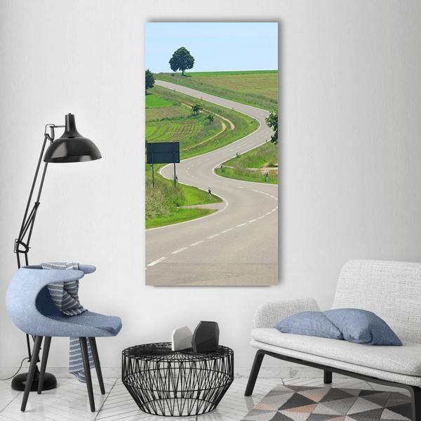 Country Road in Germany Vertical Canvas Wall Art in gray, green and blue, single vertical panel hung on a wall