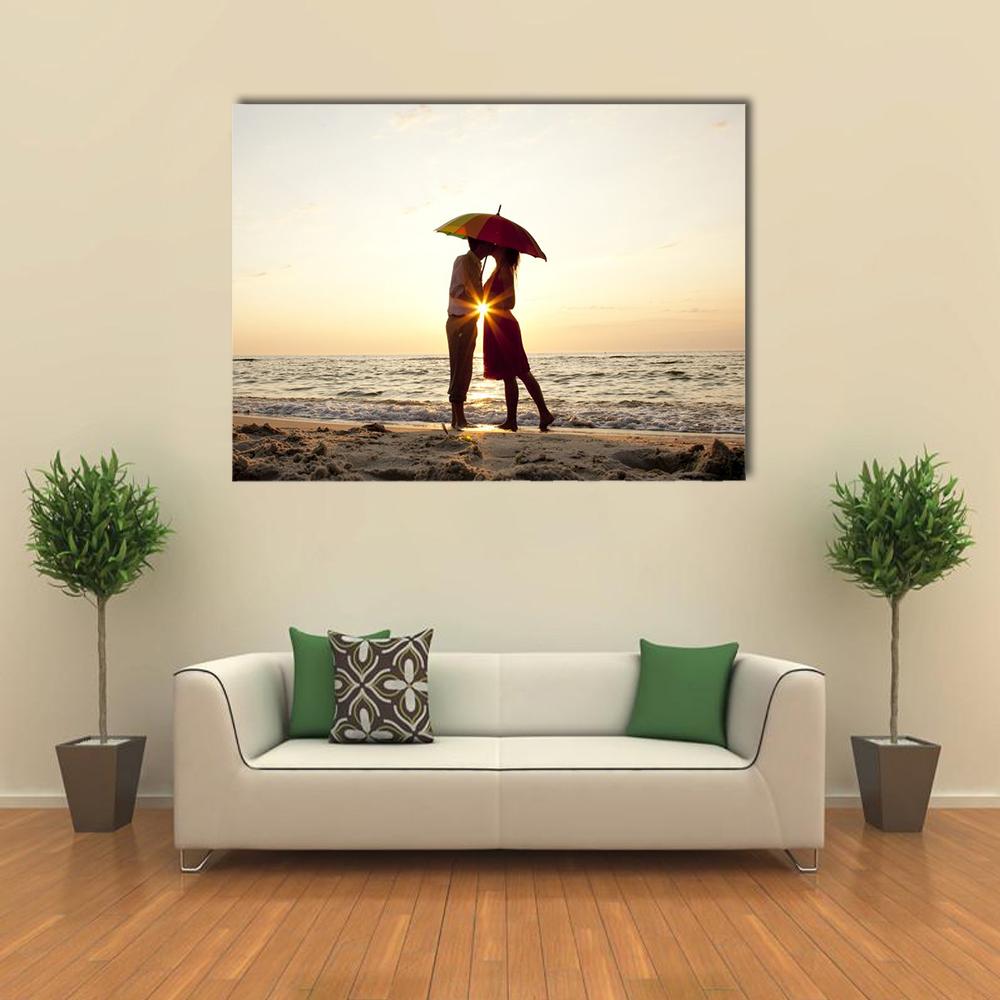 Couple Under Rainbow Umbrella at Sunset Canvas Wall Art in black, beige and yellow, single panel hung on a wall