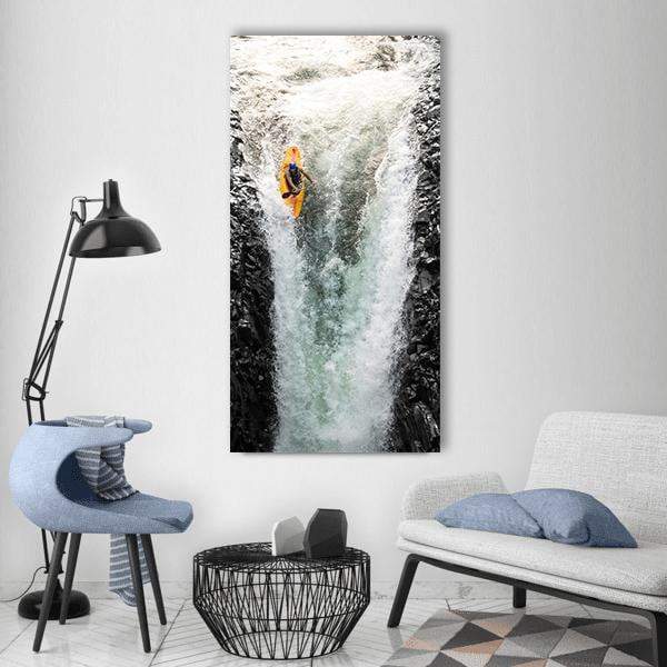 Kayaker Diving Over Waterfall Vertical Canvas Wall Art in black, white and green, single vertical panel hung on a wall