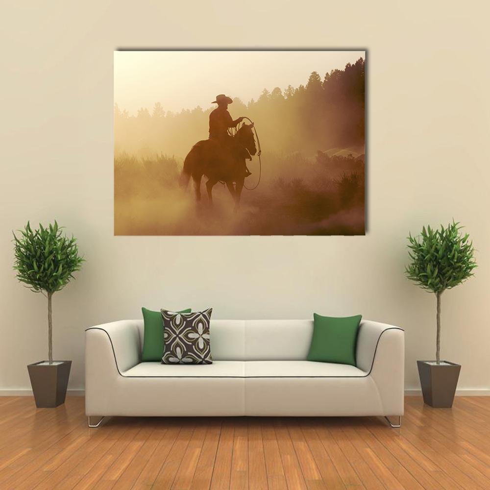Cowboy Silhouette at Setting Sun Canvas Wall Art in black, brown and yellow, single panel hung on a wall