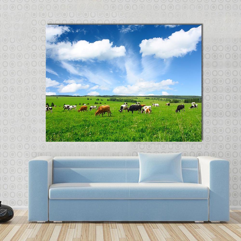 Cows in Green Meadow Canvas Wall Art in white, green and blue, single panel hung on a wall