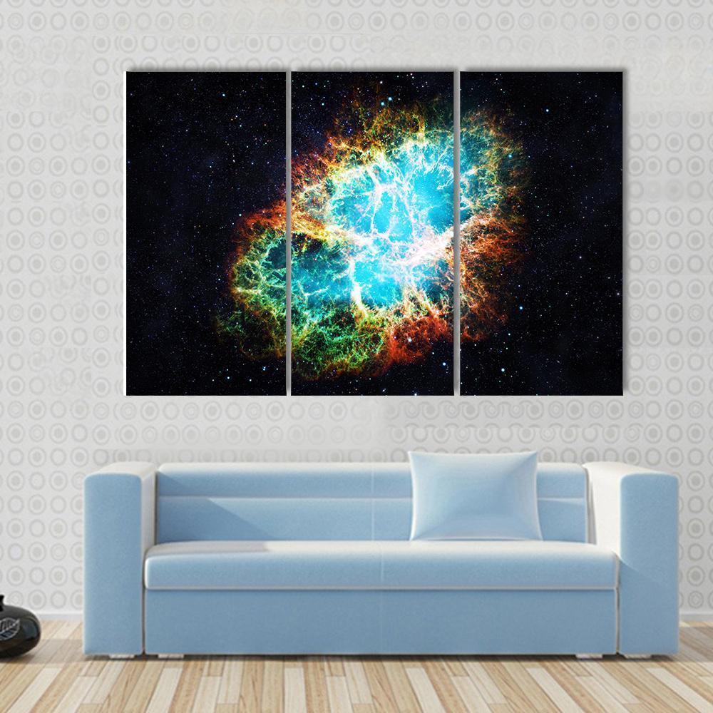 Crab Nebula Canvas Wall Art in black, orange and blue, 3 panel horizontal set hung on a wall