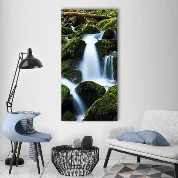 Creek Falls with Mossy Rocks Vertical Canvas Wall Art in white, brown and green, single vertical panel hung on a wall