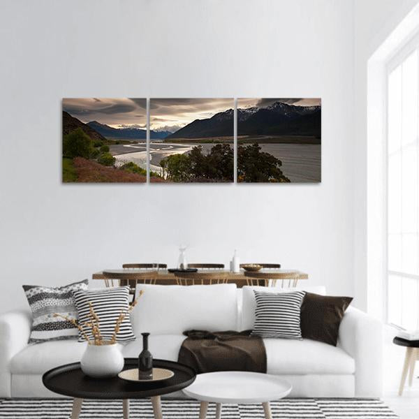 Dusk Clouds Over Mountain Lake Panoramic Canvas Wall Art in gray, beige and brown, hung on a wall