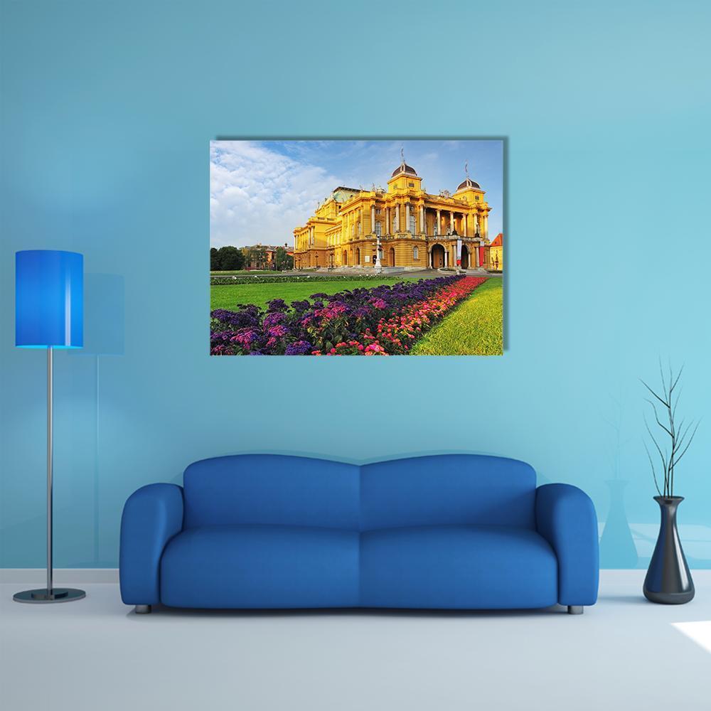 Croatian National Theater with Flowerbeds Canvas Wall Art in yellow, green and blue, single panel hung on a wall