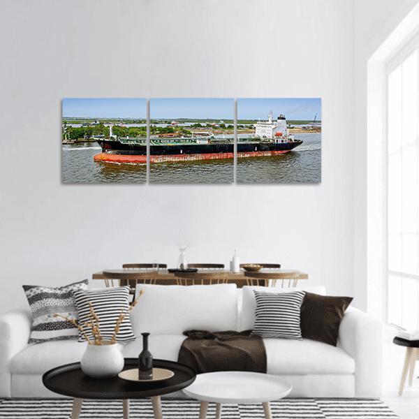 Unloaded Oil Tanker Panoramic Canvas Wall Art in black, green and blue, hung on a wall