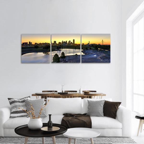 Dallas Skyline at Sunrise Panoramic Canvas Wall Art in orange, yellow and blue, hung on a wall