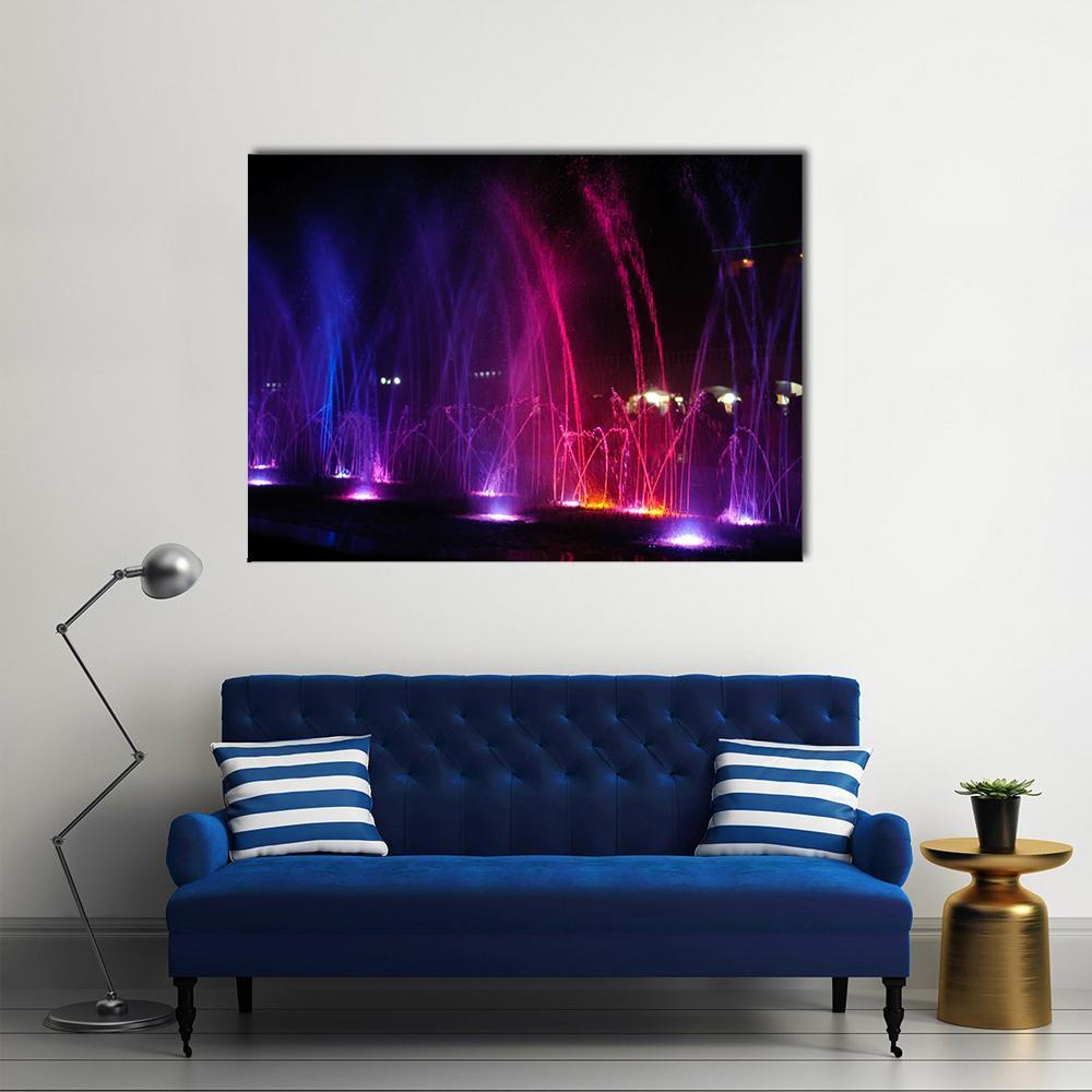 Dancing Fountains at Night Canvas Wall Art in black, blue and pink, single panel hung on a wall