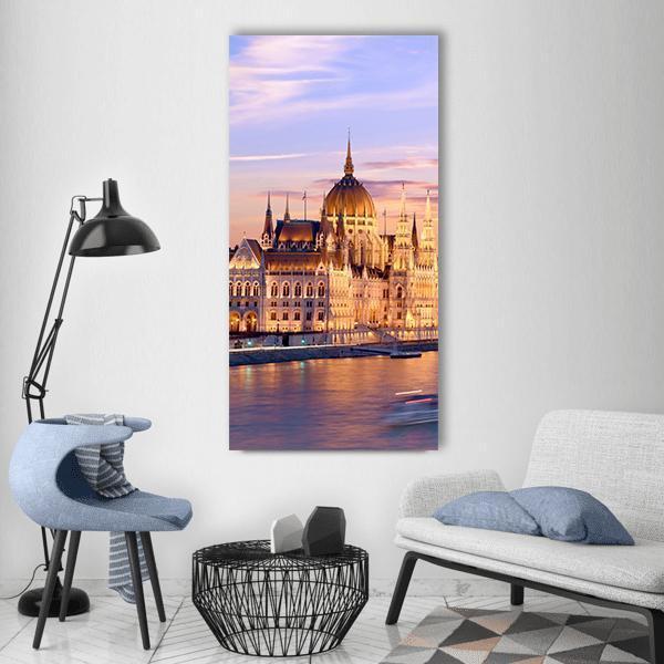 Hungarian Parliament and Danube at Sunset Vertical Canvas Wall Art in orange, blue and purple, single vertical panel hung on a wall