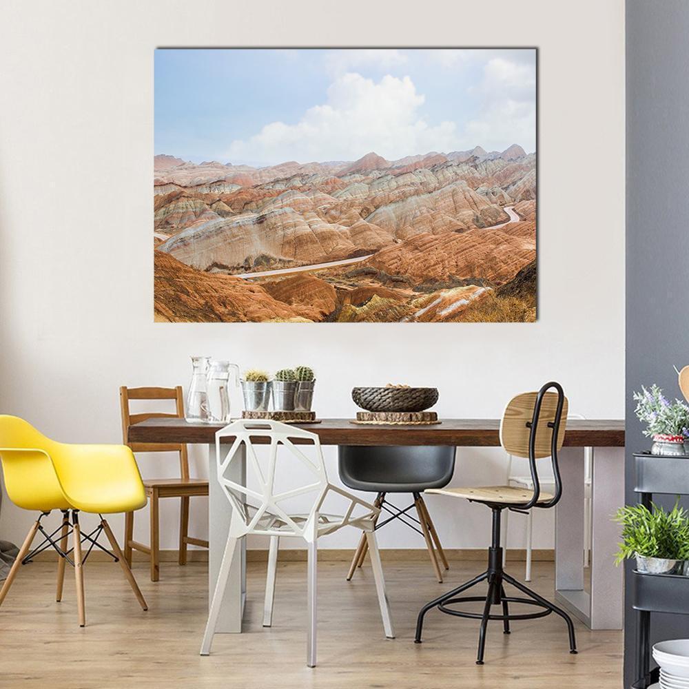 Danxia Rainbow Mountains in Daylight Canvas Wall Art in brown, orange and blue, single panel hung on a wall