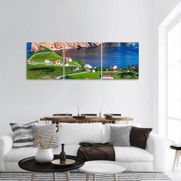 Coastal Village with Red Roofs and Bay Panoramic Canvas Wall Art in brown, green and blue, hung on a wall